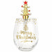 A clear stemless wine glass with gold 'Merry Christmas' lettering and a gold tree design, topped with a gold Christmas tree ornament featuring a red star and red ornaments, on a white background.