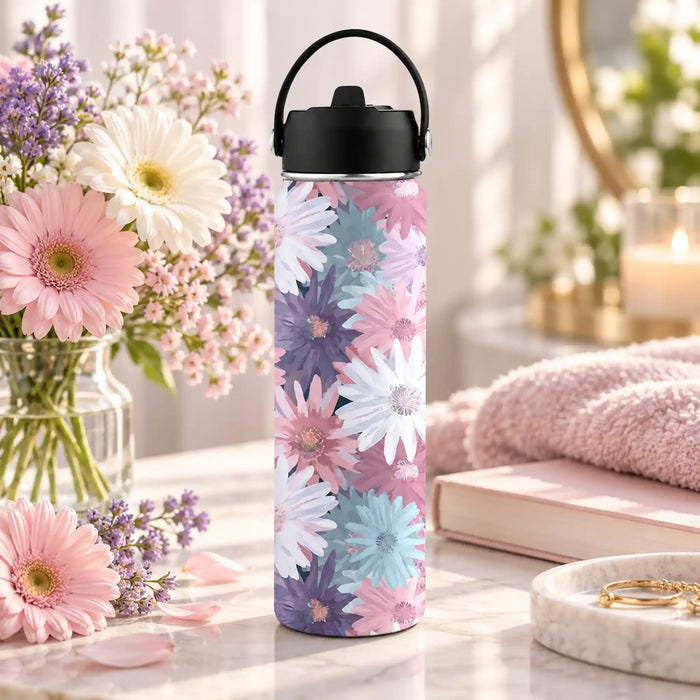 Quiet Blossom 620ml insulated water bottle with pastel daisy artwork, styled beside fresh flowers and a pink towel.