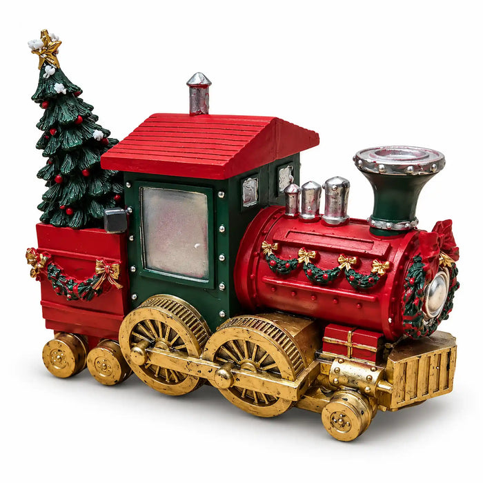 A festive Christmas train decoration with a red body, green cab, gold wheels, and a decorated green tree on the side, shown on a plain white background.