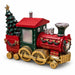 A festive Christmas train decoration with a red body, green cab, gold wheels, and a decorated green tree on the side, shown on a plain white background.