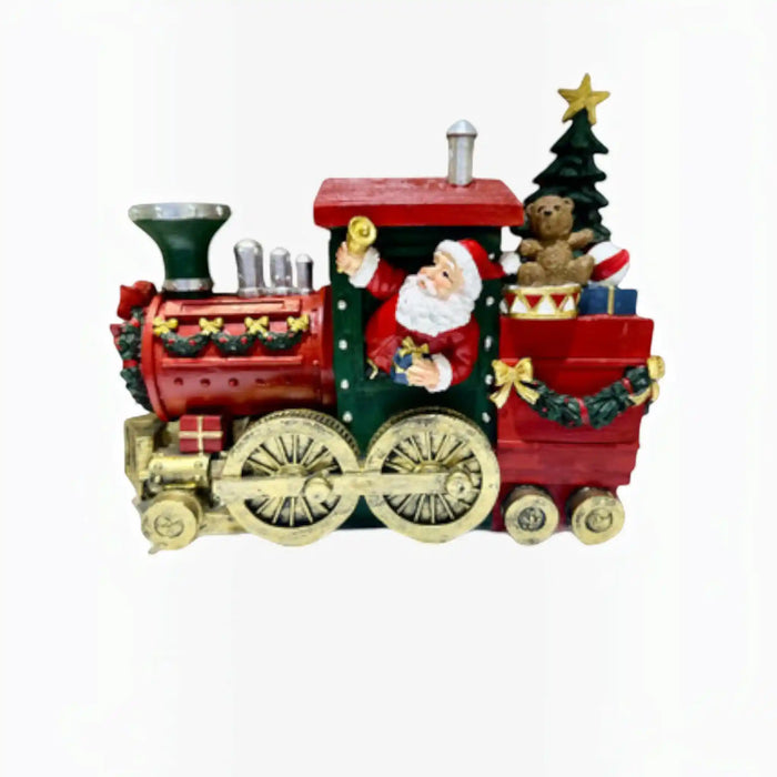 A festive Christmas train figurine with Santa Claus in the cab, a small teddy bear, a decorated Christmas tree, and gold-toned wheels on a plain white background.