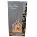 A boxed holiday decoration labeled 'Snow Water Lantern' showing a church-shaped lantern with glowing warm lights and a snow-covered scene on the front of the packaging.