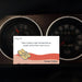 Card with flip-flops and text over a car dashboard with gauges