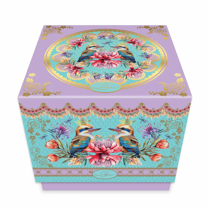 A decorative gift box with a lavender purple base and ornate turquoise, gold, pink, and blue floral bird illustrations, photographed on a clean white background.