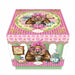 A decorative gift box featuring the Wonda Wombat character wearing pink glasses and a headband, surrounded by pink gingham patterns, floral illustrations, and tea-time motifs, photographed on a clean white background.