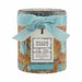 William Morris 'At Home' Bathing Gift Set in a round tin container with a light blue velvet ribbon bow and a hanging paper tag, on a white background.