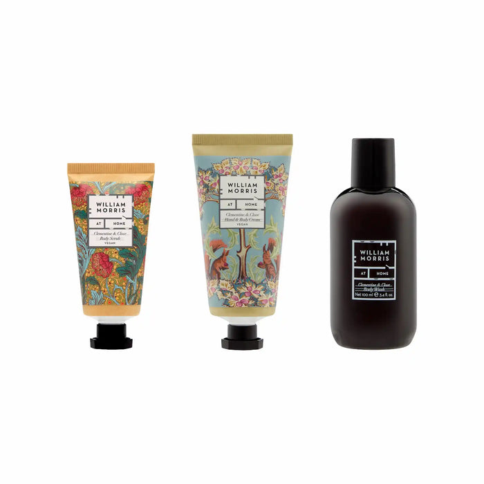 Three William Morris home fragrance products on a white background: a hand cream tube, a body wash tube, and a cologne bottle.