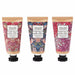 Three William Morris 'At Home' hand cream tubes with black caps, displayed side-by-side against a white background. Each tube features a different botanical pattern: a pink damask on the left, a blue floral on the center, and a pink botanical on the right.