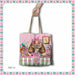 A tote bag with a whimsical cartoon sloth tea party print, held by a hand against a white background with a decorative pink and teal border.